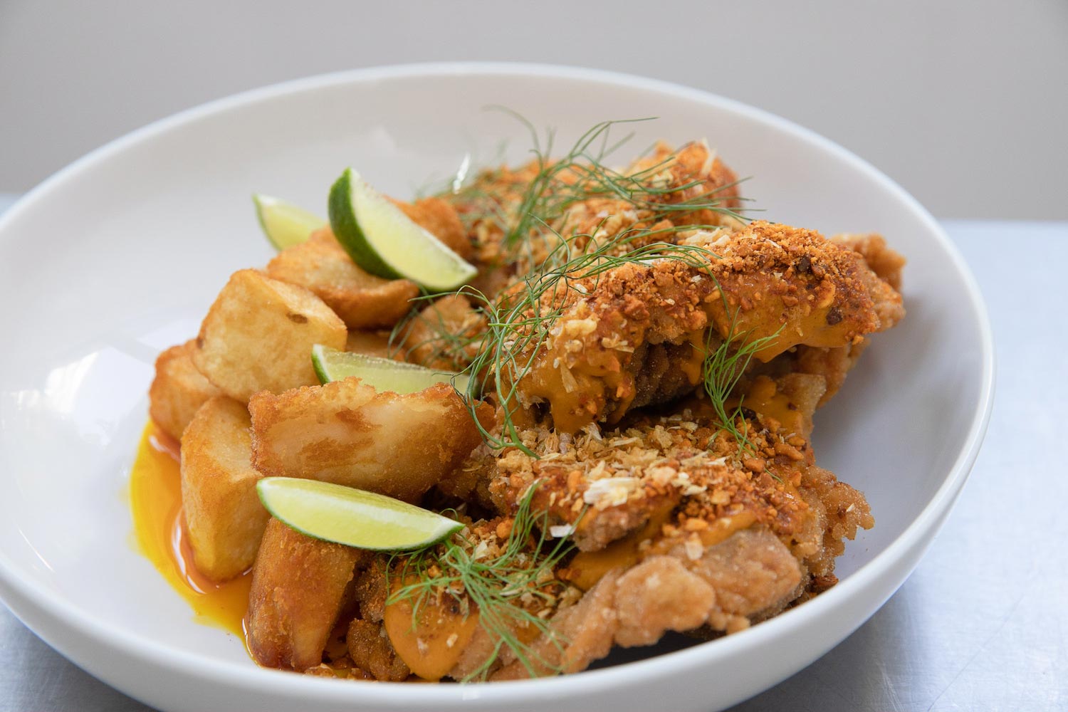 Bonbite family style main dish fried chicken and potatoes with crispy garlic and lime